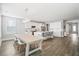 Bright, open kitchen and dining area with hardwood floors, island seating, and modern lighting at 204 Corvus St, Summerville, SC 29483