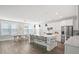 Open-concept kitchen and dining area with marble island seating, modern appliances, and ample natural light at 204 Corvus St, Summerville, SC 29483