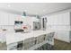 Spacious kitchen features a large marble island with seating, modern appliances and white cabinetry at 204 Corvus St, Summerville, SC 29483