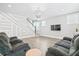 Bright living room with gray wood flooring, custom wall paneling, decorative chandelier and comfortable gray seating at 204 Corvus St, Summerville, SC 29483