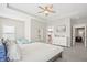 Bright main bedroom with ceiling fan, ensuite access, and white dresser for ample storage at 204 Corvus St, Summerville, SC 29483