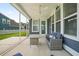 Inviting screened-in porch featuring stylish seating and dining area with views of the backyard at 204 Corvus St, Summerville, SC 29483