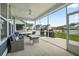 Screened in patio with ceiling fan, comfortable seating, and views of the fenced yard at 204 Corvus St, Summerville, SC 29483