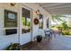 Cozy front porch with potted plants, outdoor seating, and a view of lush landscaping for relaxed outdoor living at 204 Corvus St, Summerville, SC 29483