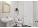 Stylish powder room featuring a pedestal sink, decorative mirror, and modern fixtures at 204 Corvus St, Summerville, SC 29483
