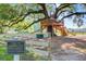 Unique community treehouse featuring multi-tiered decks, slides and walkways nestled within a lush oak tree at 204 Corvus St, Summerville, SC 29483