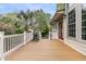Spacious wooden back deck with white railing and a grill, perfect for outdoor entertaining at 2093 Rookery Ln, Charleston, SC 29414