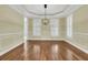 Bright dining room featuring hardwood floors, modern lighting, and decorative wall trim details at 2093 Rookery Ln, Charleston, SC 29414