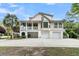 Beautifully landscaped home with three garage spaces, a covered porch, and a spacious driveway at 2093 Rookery Ln, Charleston, SC 29414