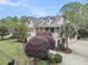 Beautiful exterior of a home, surrounded by greenery and colorful bushes and a well-manicured lawn at 2093 Rookery Ln, Charleston, SC 29414