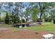 Serene pond with a fountain, surrounded by mature trees and lush greenery in a tranquil setting at 2093 Rookery Ln, Charleston, SC 29414