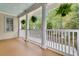 Inviting porch with classic columns and hanging ferns, offering a relaxing outdoor space with a scenic view at 2093 Rookery Ln, Charleston, SC 29414
