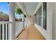 Spacious porch featuring elegant columns, hanging ferns, and ample room for seating, overlooking a garden at 2093 Rookery Ln, Charleston, SC 29414