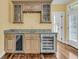 This wet bar has granite countertops, wine rack, wine refrigerator, and an beverage refrigerator at 2093 Rookery Ln, Charleston, SC 29414
