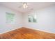 Bedroom featuring hardwood floors, neutral paint, a ceiling fan, and bright windows at 21 Hester St # Apt 12, Charleston, SC 29403