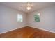 Spacious bedroom with hardwood floors, neutral paint, a ceiling fan, and bright windows at 21 Hester St # Apt 12, Charleston, SC 29403