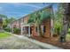Charming brick townhomes with black shutters and mature palm trees offering curb appeal at 21 Hester St # Apt 12, Charleston, SC 29403