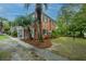 Charming brick townhome with tropical palm trees, black shutters, and green space at 21 Hester St # Apt 12, Charleston, SC 29403