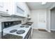 Well-lit kitchen showcases white cabinets, stone backsplash, and modern appliances at 21 Hester St # Apt 12, Charleston, SC 29403