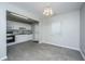 Charming kitchen with white cabinets, stone backsplash, and tiled flooring, creating an inviting space at 21 Hester St # Apt 12, Charleston, SC 29403