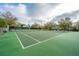 Community tennis court with a net and fenced perimeter at 21 Hester St # Apt 12, Charleston, SC 29403