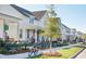 Charming street view of new construction single Gathering homes with sidewalks and landscaping on a sunny day at 211 Clearpath Dr, Summerville, SC 29486