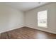 Neutral bedroom with wood flooring, white trim and lots of light from the exterior window at 214 Garden Gate Way, Summerville, SC 29486