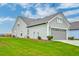 Exterior view of a well-kept home with a garage and green lawn at 214 Garden Gate Way, Summerville, SC 29486