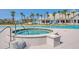 Inviting outdoor hot tub surrounded by palm trees and seating, perfect for relaxation near the pool at 214 Garden Gate Way, Summerville, SC 29486
