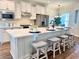 Modern kitchen featuring white cabinets, stainless steel appliances, and a large center island with seating at 214 Garden Gate Way, Summerville, SC 29486