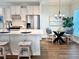 Kitchen and dining area featuring modern appliances, white cabinetry, and wood floors at 214 Garden Gate Way, Summerville, SC 29486