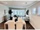Bright open-concept living room with hardwood floors, large windows and stylish modern furniture at 214 Garden Gate Way, Summerville, SC 29486