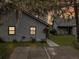 Charming home exterior with gray siding and driveway and lawn with trees nearby at 2196 Spoleto Ln, North Charleston, SC 29406