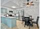 Modern kitchen features aqua cabinets, stainless steel refrigerator, and adjacent dining area at 2196 Spoleto Ln, North Charleston, SC 29406