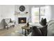Bright living room with a fireplace, accent chair, and open window view at 2196 Spoleto Ln, North Charleston, SC 29406