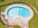 Aerial view of a kidney-shaped community pool surrounded by green grass and a white fence at 2196 Spoleto Ln, North Charleston, SC 29406