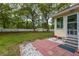 Backyard patio with a view of the lawn, trees, and a charming shed at 2233 Glendale Dr, Charleston, SC 29414