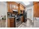 Well-lit kitchen featuring wood cabinets, stainless steel appliances, and stylish backsplash at 2233 Glendale Dr, Charleston, SC 29414