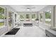 Sunroom filled with lots of windows and neutral tile floors at 2233 Glendale Dr, Charleston, SC 29414