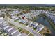 A birds eye view shows a neighborhood with well-maintained homes surrounding a scenic pond and lush greenery at 2237 Tillage St, Mount Pleasant, SC 29466