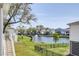 Serene backyard with pond and fountain, surrounded by lush landscaping and neighboring homes at 2237 Tillage St, Mount Pleasant, SC 29466