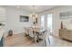 Elegant dining area with stylish lighting fixture, hardwood floors, and access to outdoor space at 2237 Tillage St, Mount Pleasant, SC 29466