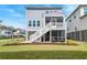 Exterior of a light blue home with a screened porch and white staircase and landscaping at 2237 Tillage St, Mount Pleasant, SC 29466