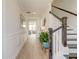 Inviting hallway features pristine hardwood floors, staircase, stylish decor and natural light at 2237 Tillage St, Mount Pleasant, SC 29466