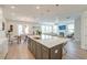 Open-concept kitchen featuring a large island with seating and modern pendant lighting at 2237 Tillage St, Mount Pleasant, SC 29466