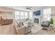 Bright living room with fireplace, plush sofa, ceiling fan, and hardwood flooring at 2237 Tillage St, Mount Pleasant, SC 29466
