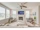 Cozy living room with fireplace, a white sofa, modern ceiling fan and bright windows at 2237 Tillage St, Mount Pleasant, SC 29466