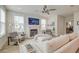 Bright living room with white sofa, fireplace, modern ceiling fan, and large windows at 2237 Tillage St, Mount Pleasant, SC 29466