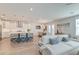 Open living space showcases hardwood floors, a kitchen with island, white sofa and dining area at 2237 Tillage St, Mount Pleasant, SC 29466