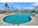 Large community pool with ladders and surrounded by new homes, palm trees, and lounge chairs for ultimate relaxation at 2237 Tillage St, Mount Pleasant, SC 29466